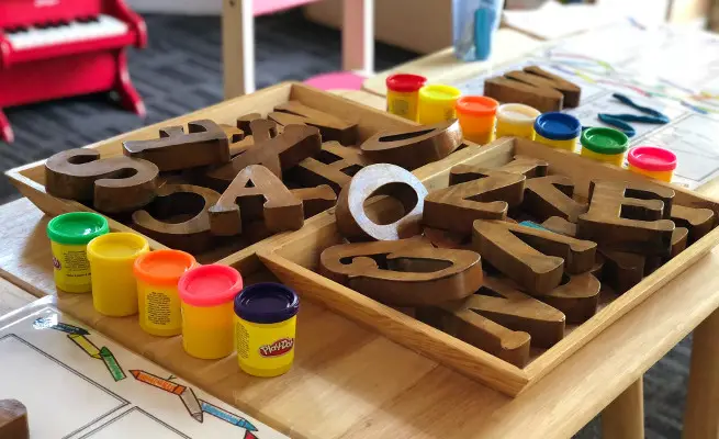 Wooden letters and paints at a kindergarten